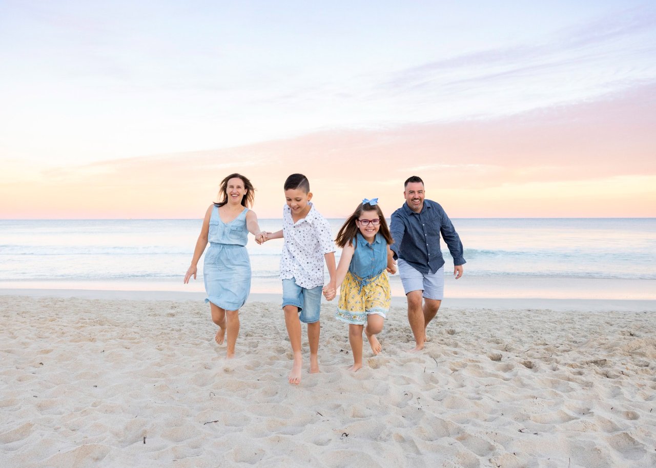 A family on a Perth beach at sunset